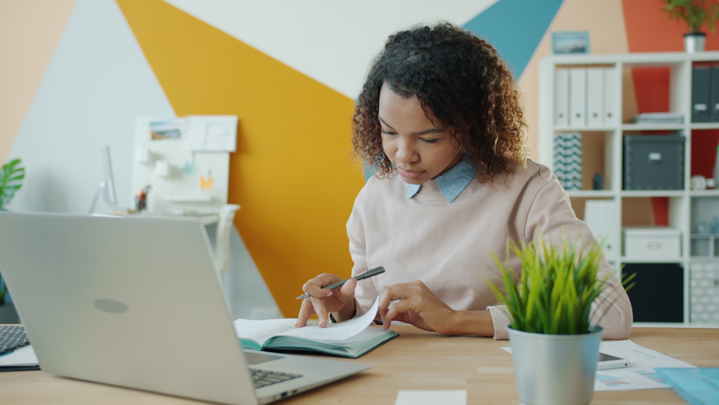 Person reviewing household finance documents at a table